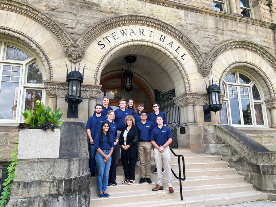 Dr. Atkins and the PSA students of cohort 8 standing in front of Stewart Hall